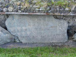 A close-up of a large stone slab with intricate carvings.