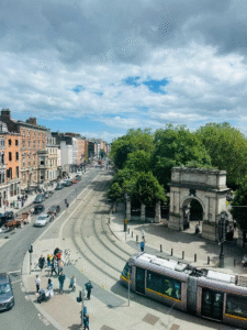 Historic street in Dublin with tram passing by.
