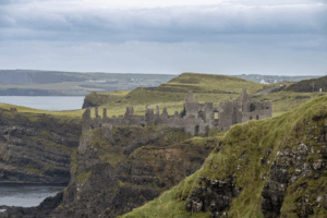 Ruined stone settlement on rugged Irish cliffs overlooking the sea