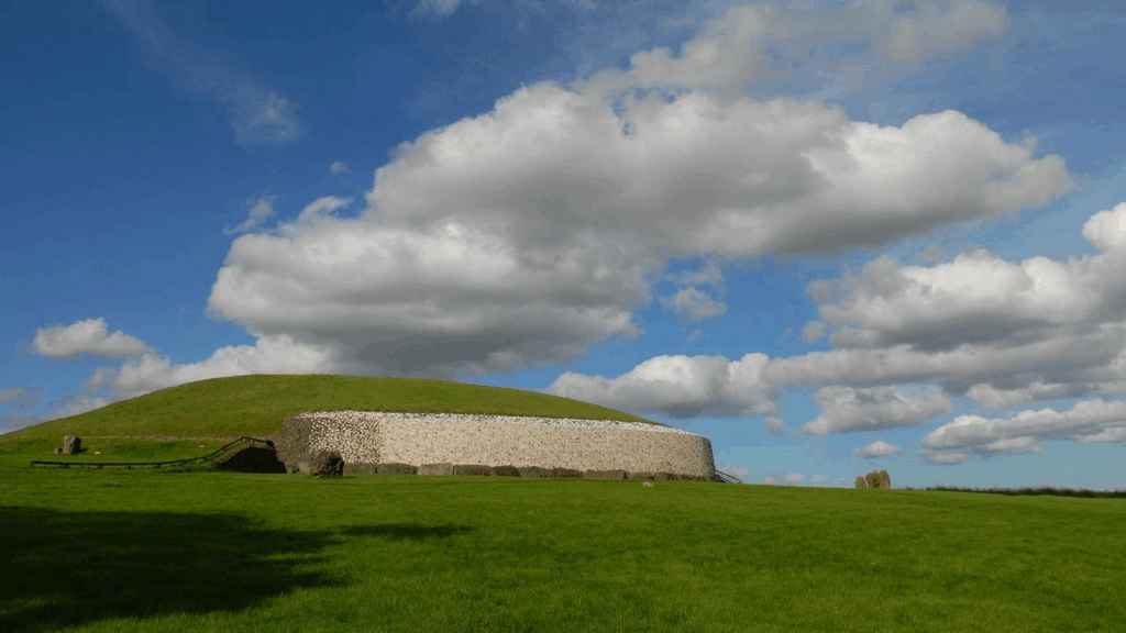 The entrance to Newgrange with its famous white stone wall and spiral carvings.