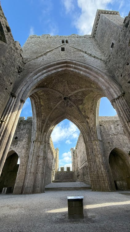 Interior of a historic Irish abbey with tall gothic arches and vaulted stone ceiling