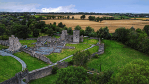 This photo is an aerial view of historical ruins surrounded by green trees.