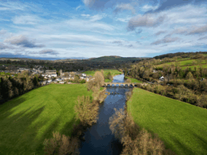 This photo is an aerial view of greenery and a river.