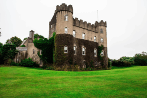 This photo shows a castle with greenery around it.