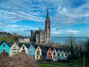 Historic colorful building exterior under a bright blue sky in Cobh, County Cork, Ireland.