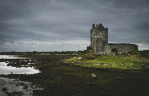 Stone Neo-Gothic church of Kylemore Abbey reflected in the water of Pollacapall Lough in County Galway.