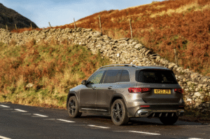 This photo shows a car parked beside a quiet Irish country road.