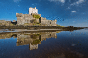 An image of a castle reflecting on a body of water
