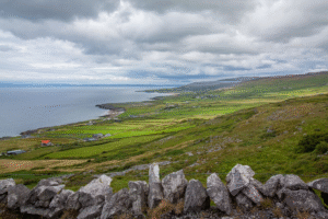 Breathtaking coastal landscape with green fields under sky