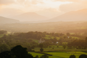 Panoramic view of Irish countryside with castle at sunset