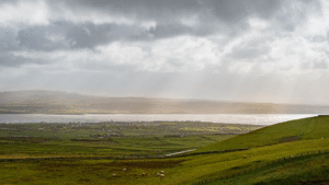 Dramatic clouds over green fields in the Burren, Clare